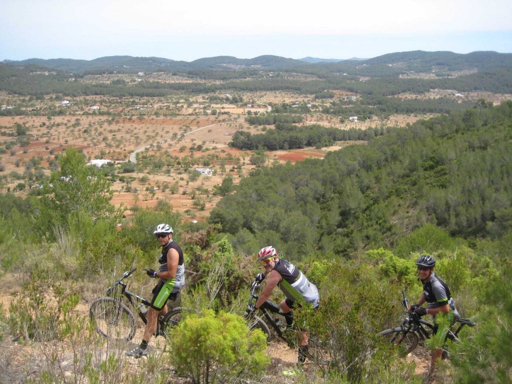 Mountain bikers on a trail overlooking the Ibiza countryside